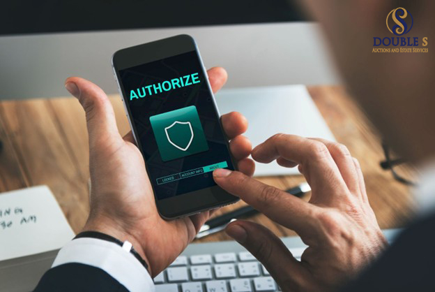 Person holding a smartphone with an authorize button on the screen