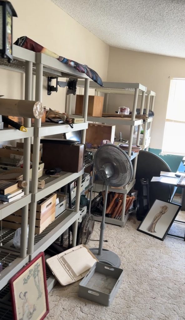 Before: a bedroom lined with full shelving units